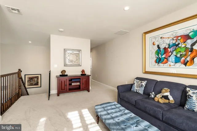 a living room with furniture and painting on the wall
