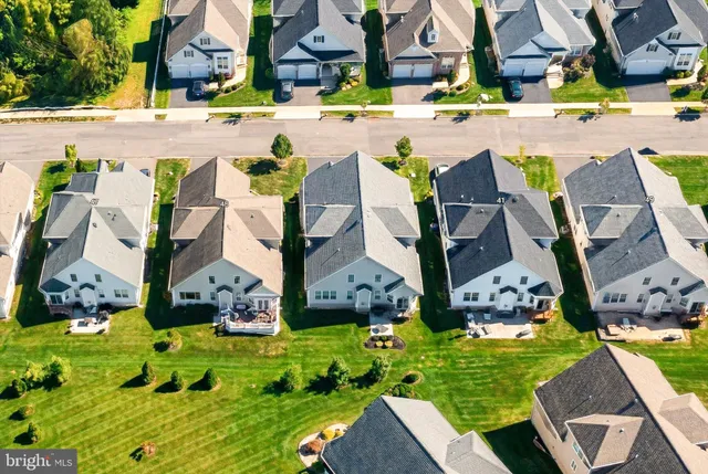 an aerial view of multiple houses with yard