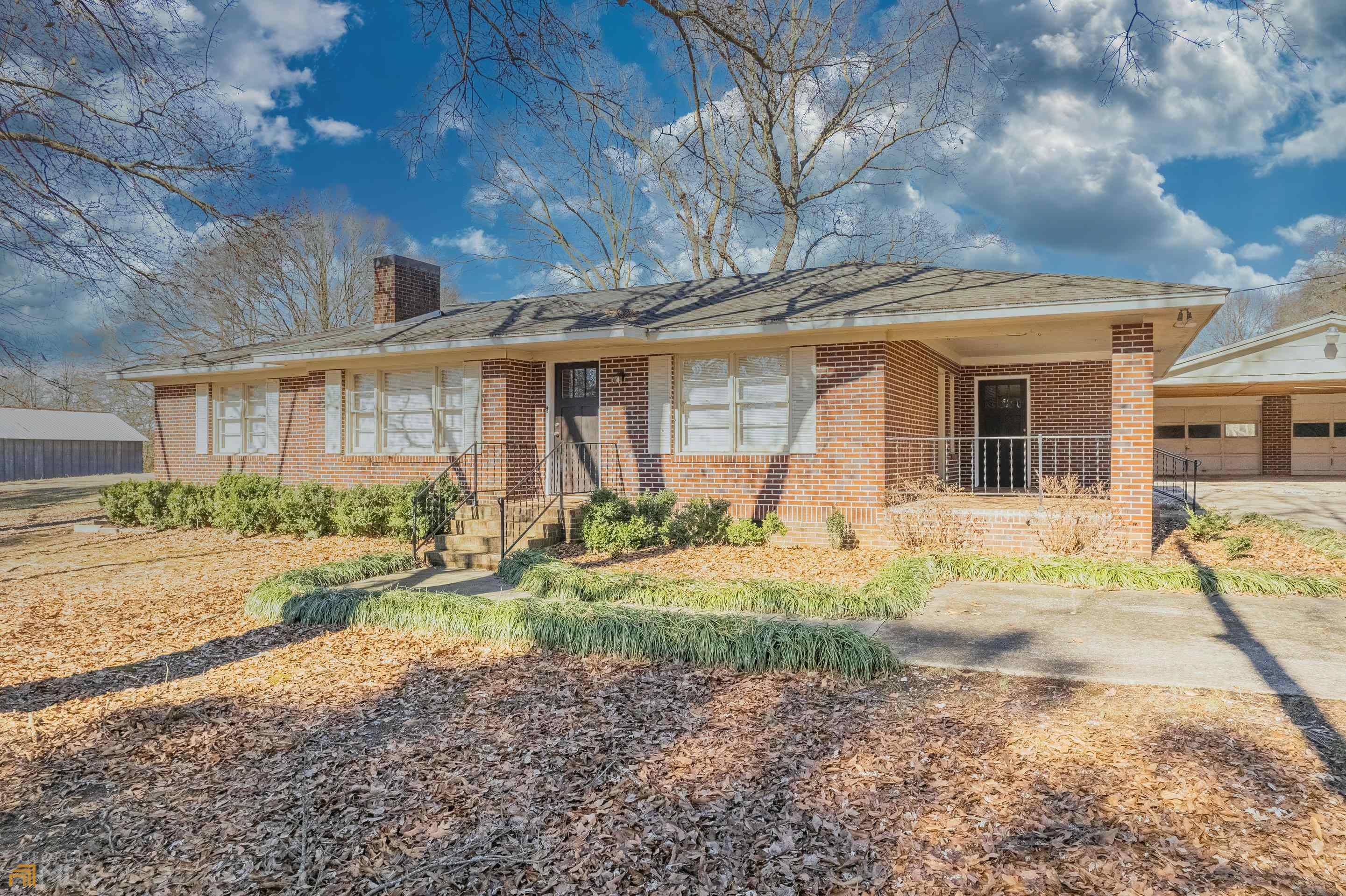 a front view of house with yard and green space