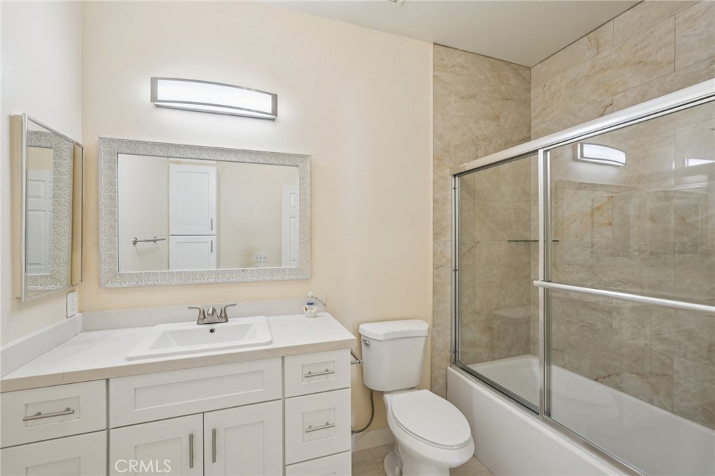 1793 Agrigento Avenue Riverside, CA 92507 - Photo 14 of 34 a bathroom with a sink toilet and shower