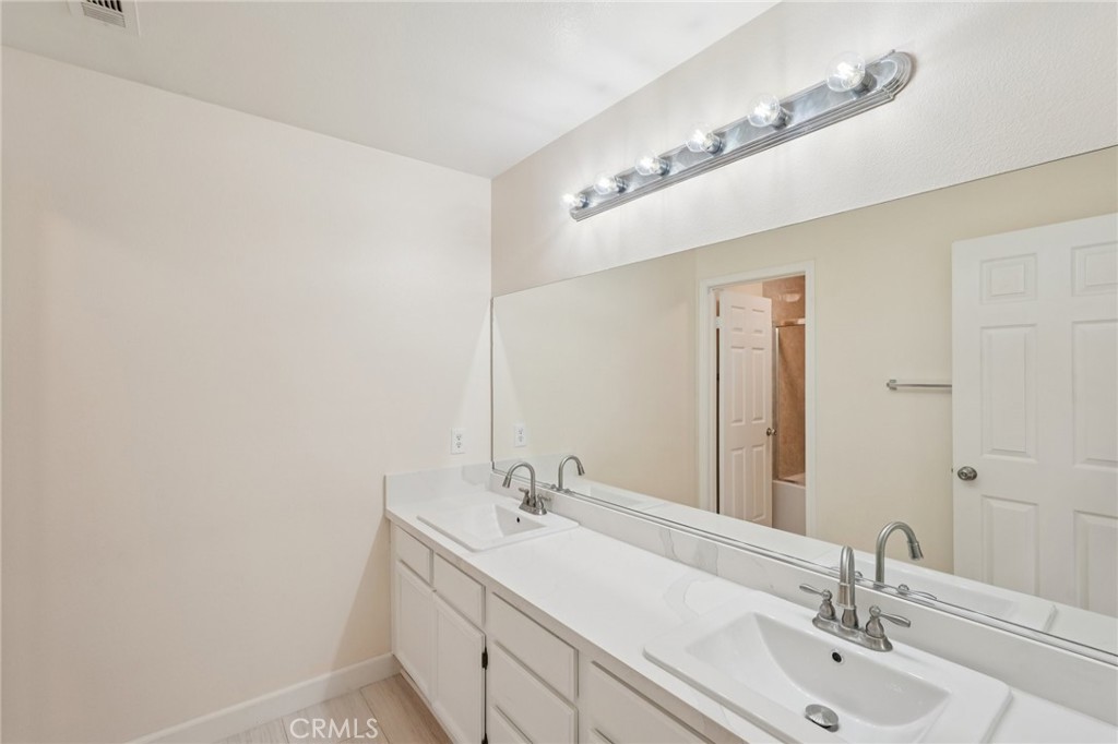 1793 Agrigento Avenue Riverside, CA 92507 - Photo 17 of 34 a bathroom with a sink and a mirror