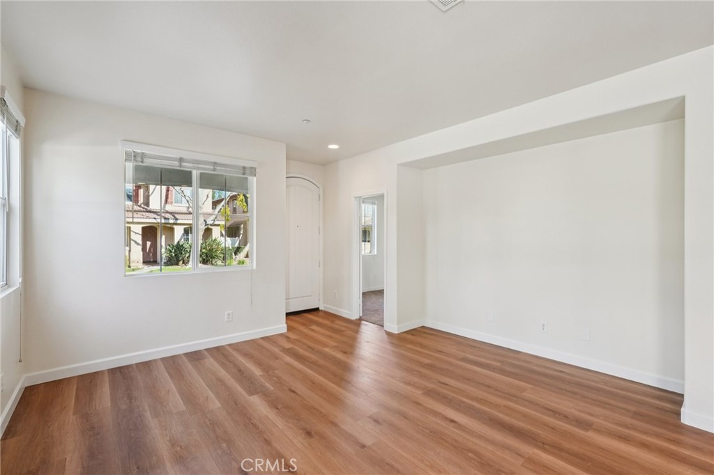 1793 Agrigento Avenue Riverside, CA 92507 - Photo 3 of 34 a view of an empty room with wooden floor and a window