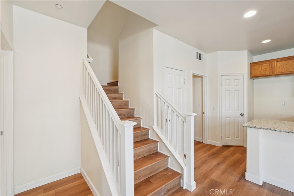 1793 Agrigento Avenue Riverside, CA 92507 - Photo 6 of 34 a view of a hallway with wooden floor and entryway