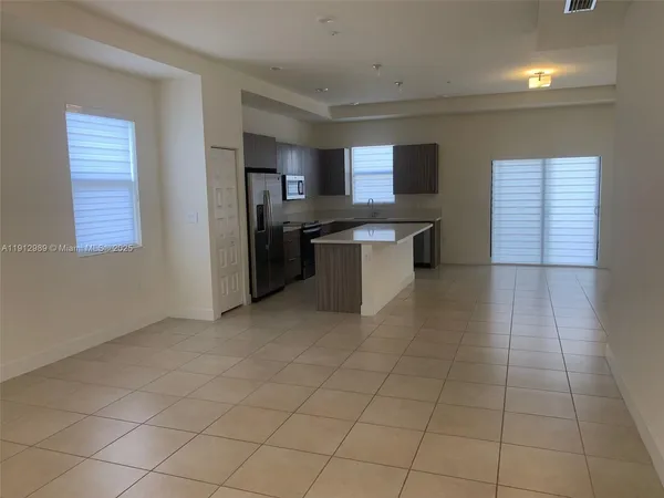 a kitchen with stainless steel appliances a sink and cabinets