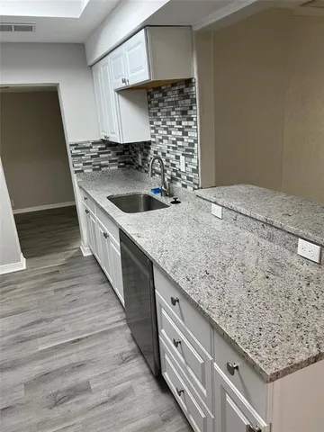 a kitchen with a sink stove and cabinets