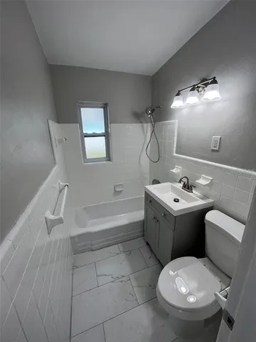 a bathroom with a sink mirror vanity and toilet