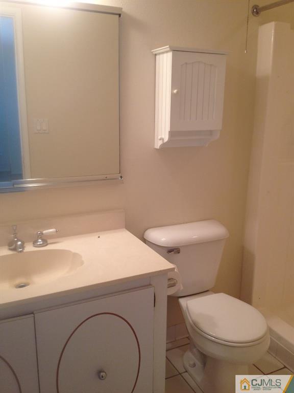 38 C Haddon Road Monroe Township, NJ 08831 - Photo 14 of 19 a bathroom with a toilet a sink and mirror