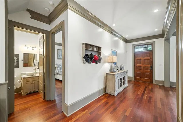 a kitchen with a table chairs and wooden floor