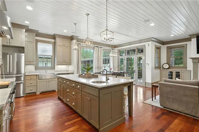 a living room with furniture a rug and a ceiling fan