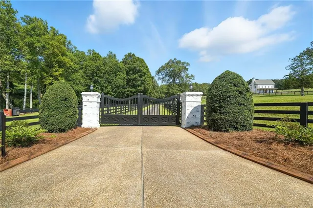 a front view of a house with swimming pool and porch