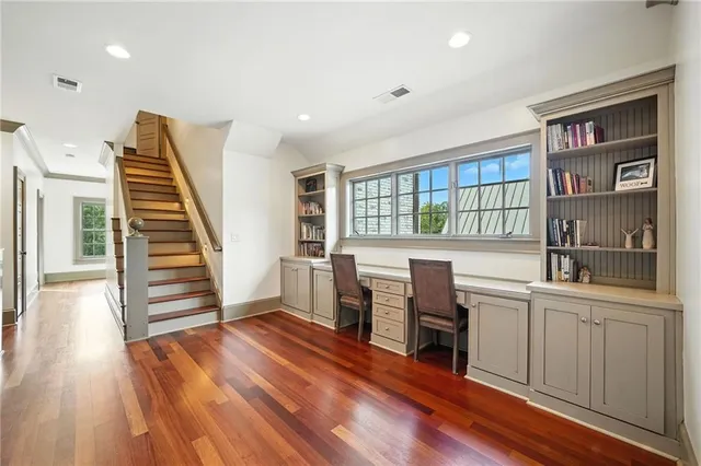a swimming pool with an outdoor seating and trees