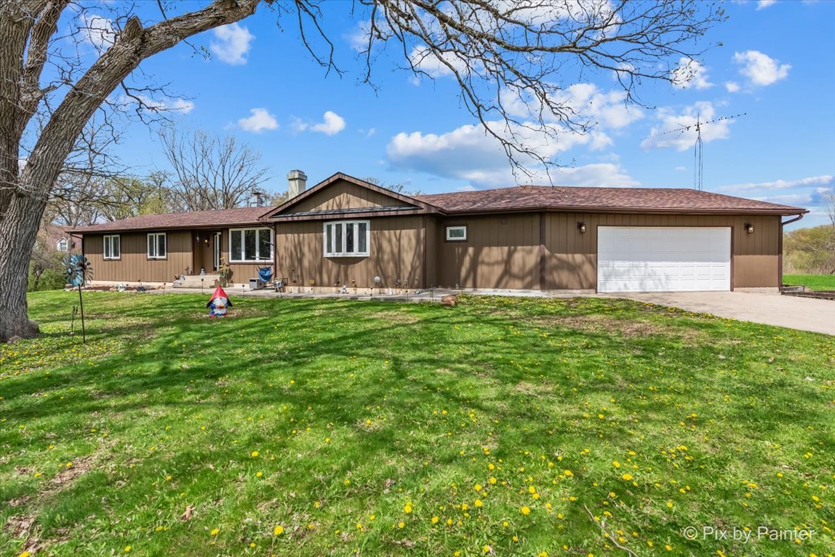 18570 Stevens Road Marengo, IL 60152 - Photo 1 of 45 a front view of a house with a yard and large tree