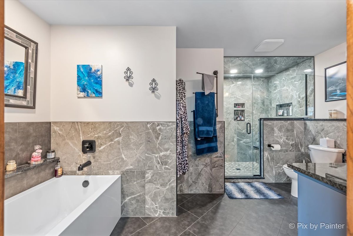 18570 Stevens Road Marengo, IL 60152 - Photo 21 of 45 a bathroom with a tub sink and shower