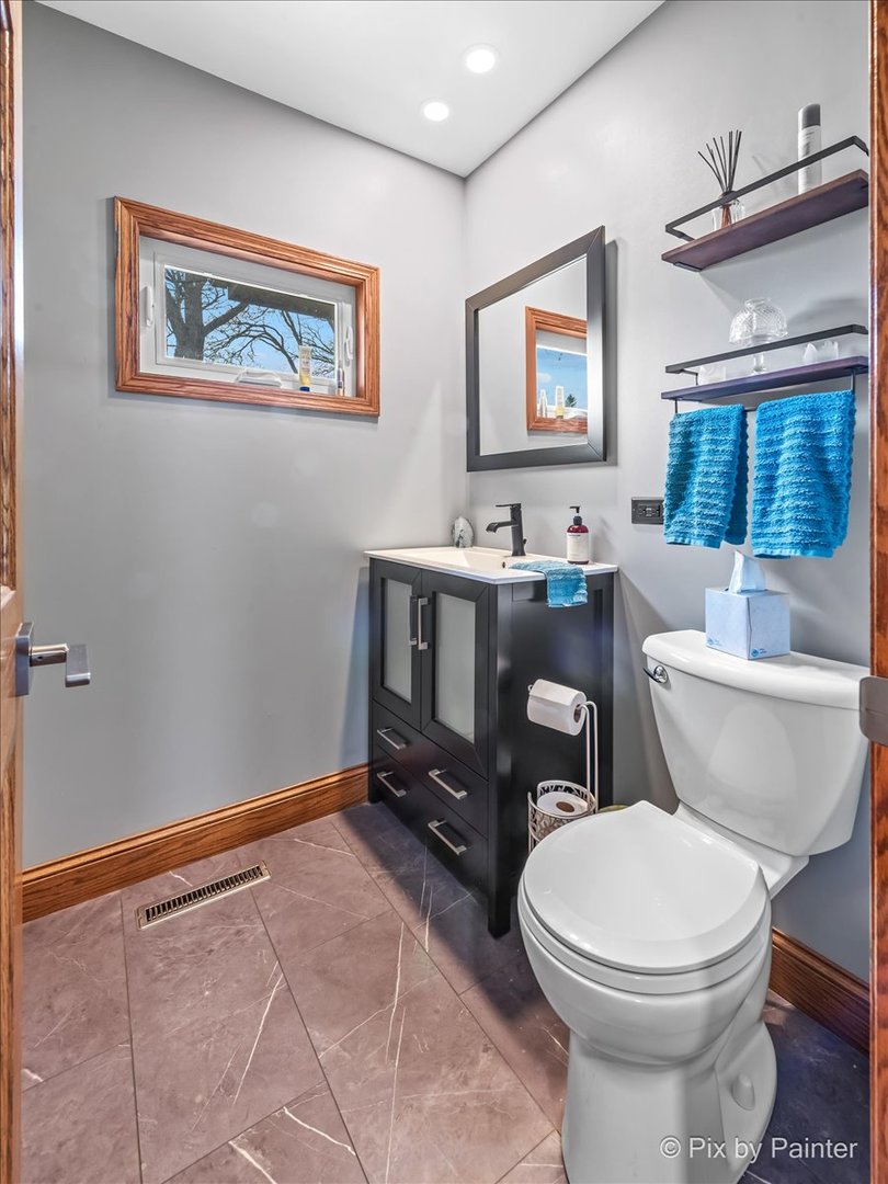18570 Stevens Road Marengo, IL 60152 - Photo 27 of 45 a bathroom with a toilet a sink and a mirror