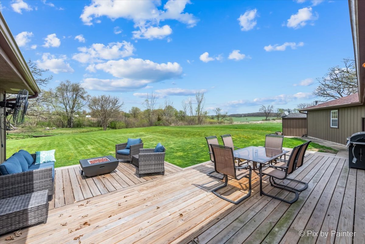 18570 Stevens Road Marengo, IL 60152 - Photo 30 of 45 a view of a patio with lawn chairs floor to ceiling window and yard