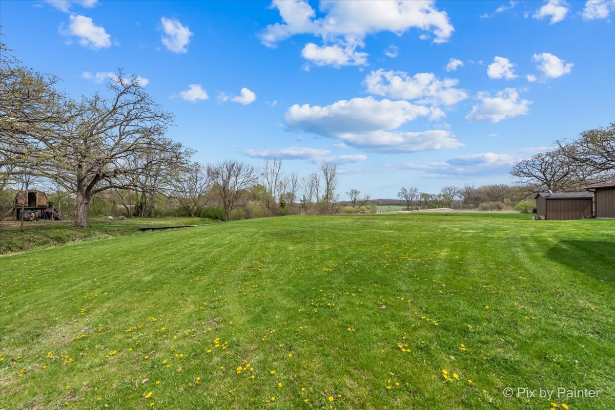 18570 Stevens Road Marengo, IL 60152 - Photo 35 of 45 a backyard of a house with lots of green space