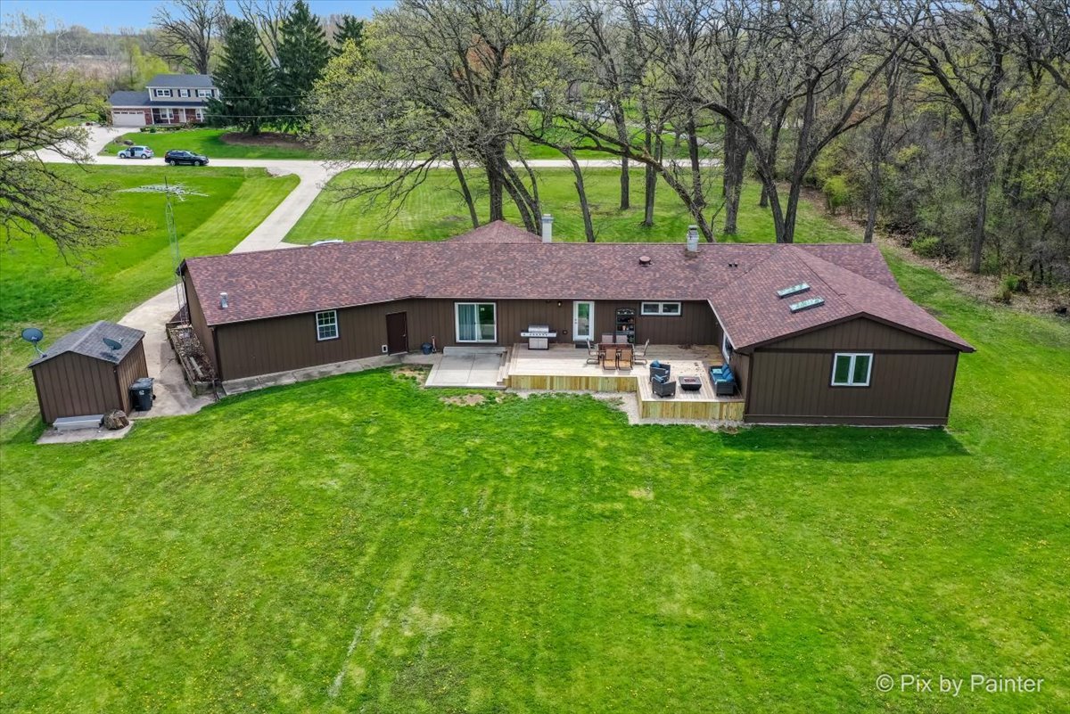 18570 Stevens Road Marengo, IL 60152 - Photo 4 of 45 a view of a house with a yard table and chairs