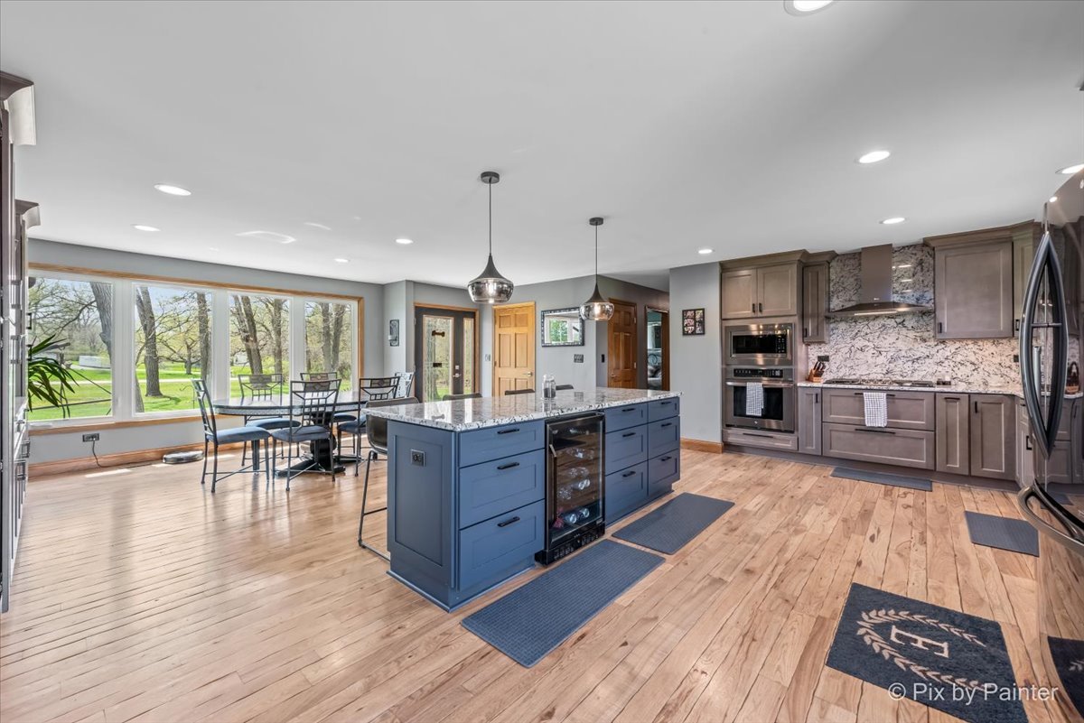 18570 Stevens Road Marengo, IL 60152 - Photo 9 of 45 a large kitchen with lots of counter space and wooden floor