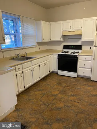 a kitchen with cabinets and appliances