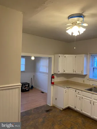 a view of a kitchen with a sink dishwasher and cabinets