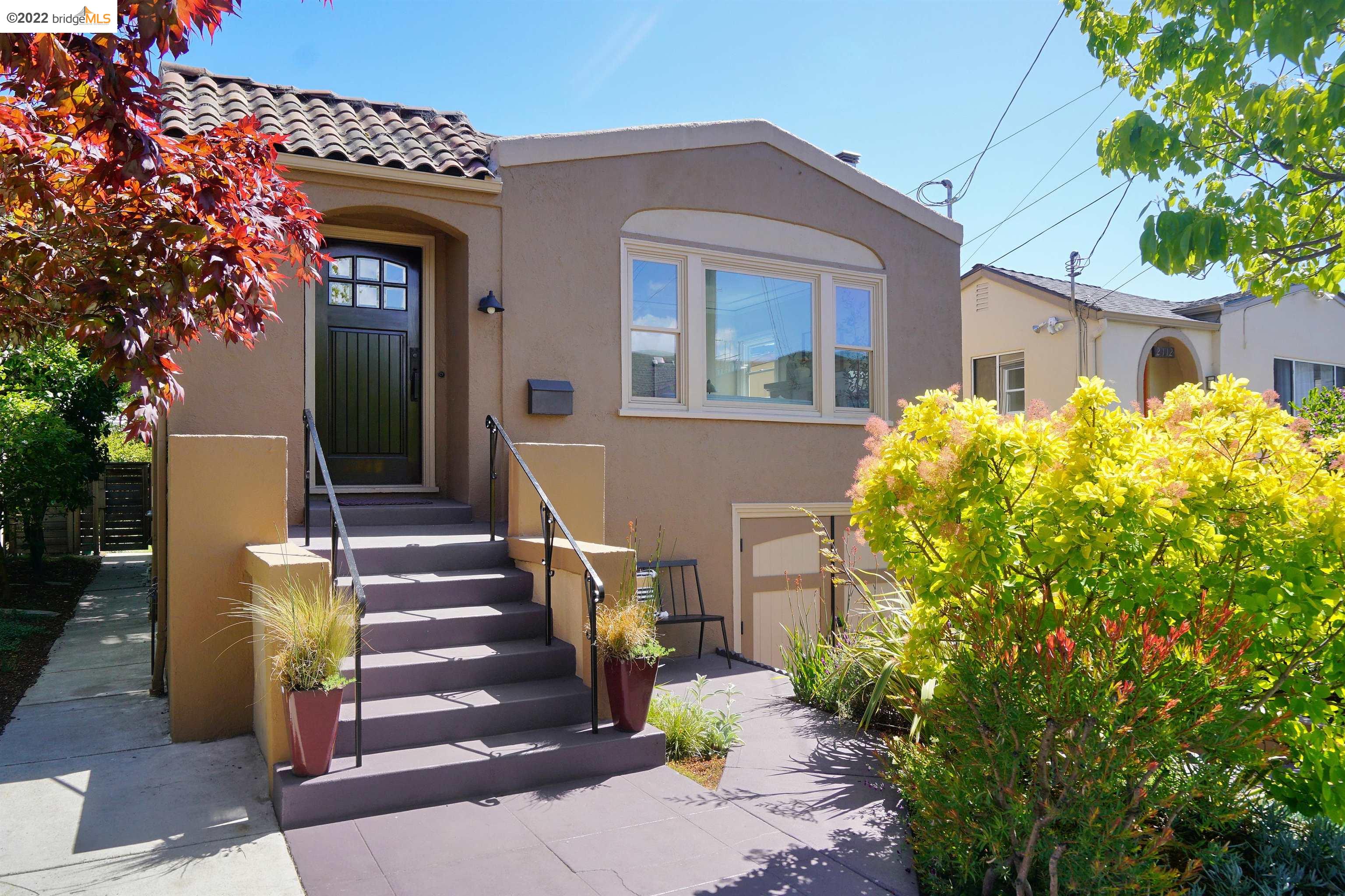 a front view of a house with a garden