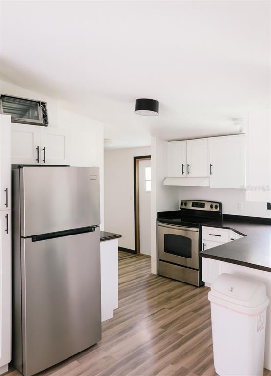 4685 D Street St. Cloud, FL 34772 - Photo 15 of 15 a kitchen with a refrigerator and a stove top oven