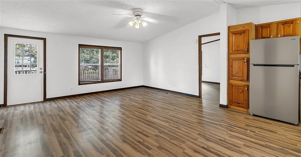 4685 D Street St. Cloud, FL 34772 - Photo 4 of 15 a view of empty room with wooden floor and fan