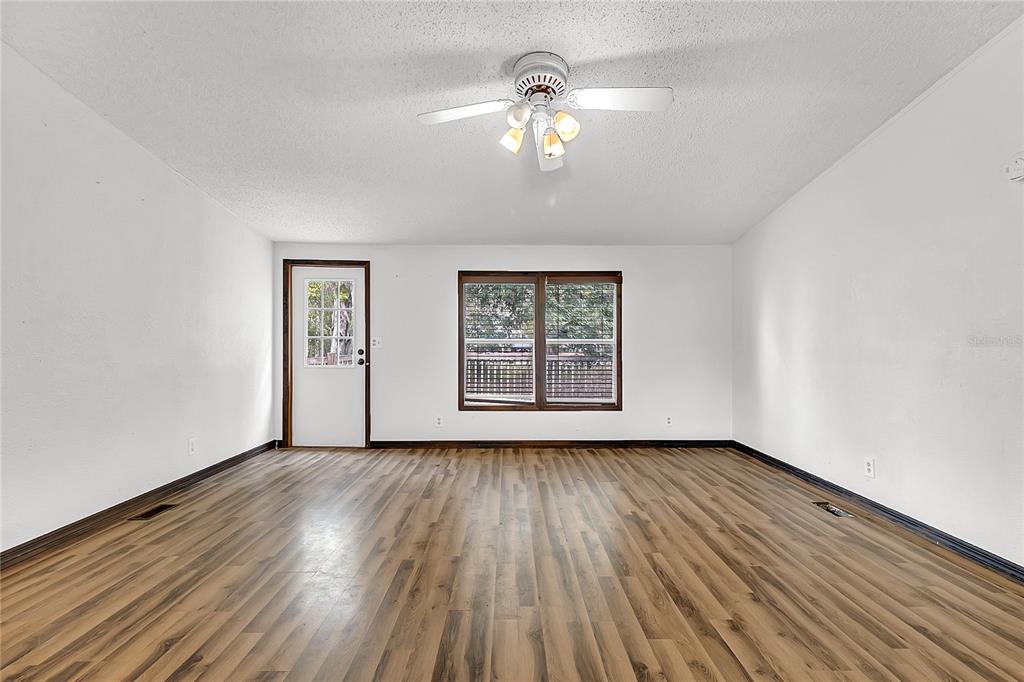 4685 D Street St. Cloud, FL 34772 - Photo 6 of 15 a view of an empty room with wooden floor and a window