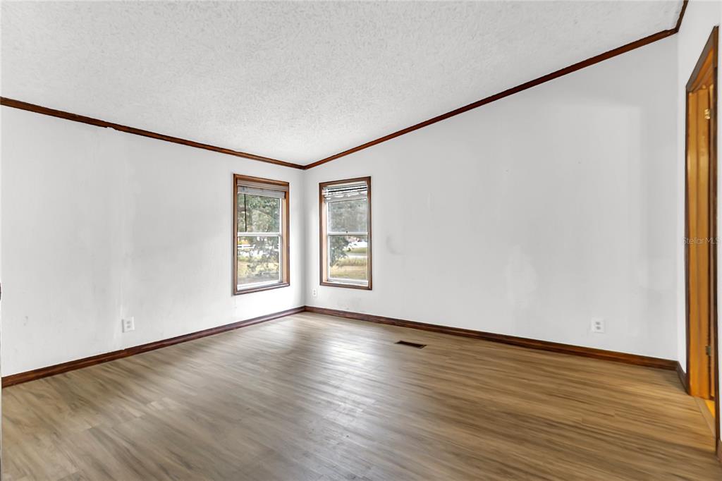 4685 D Street St. Cloud, FL 34772 - Photo 8 of 15 a view of an empty room with wooden floor and a window