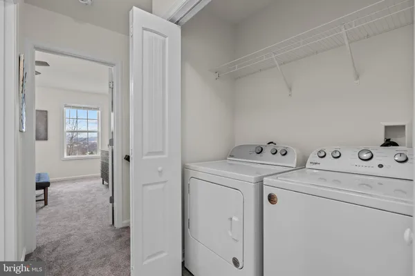 a view of storage and utility room with washer and dryer
