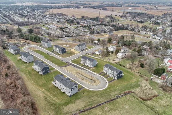 an aerial view of a residential houses with outdoor space