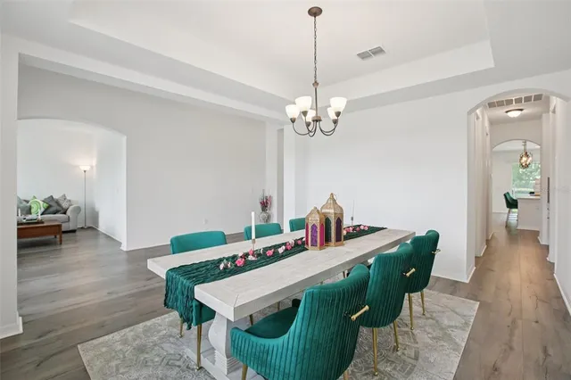 a view of a dining room with furniture and wooden floor