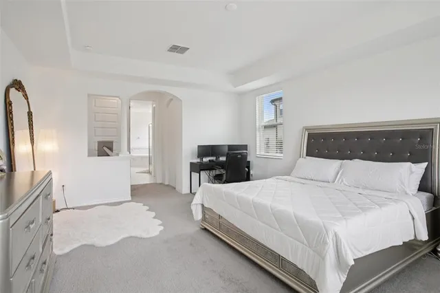 a bedroom with a bed and a television