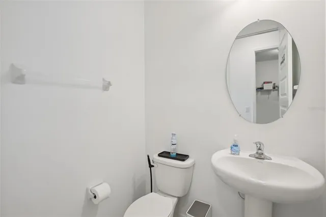 a bathroom with a sink mirror and toilet