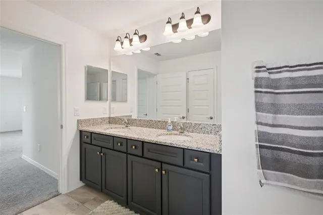 a spacious bedroom with a bed and a potted plant