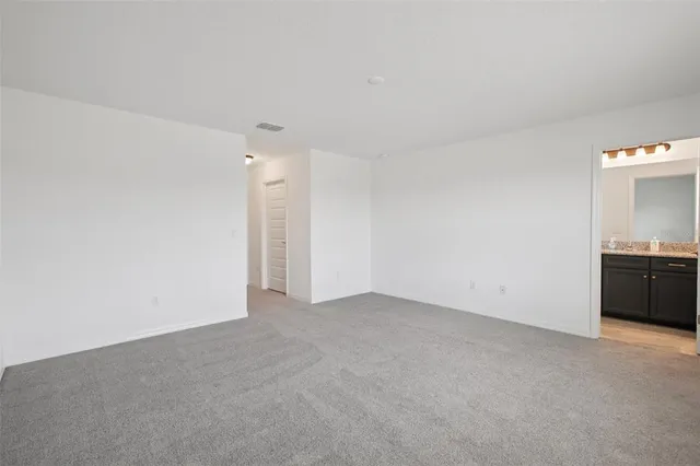 a spacious bedroom with a bed and a couch