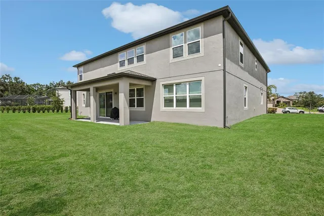 an aerial view of a house with a garden and lake view
