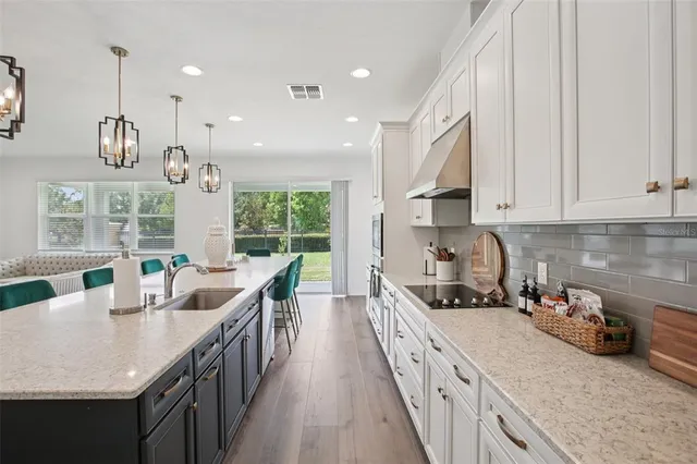 a kitchen with sink a counter and cabinets