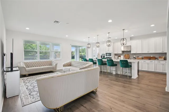 a living room with furniture and a large window