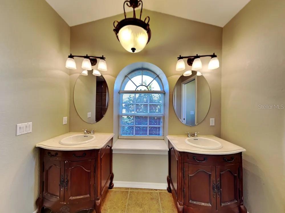 22 Cabello Street Punta Gorda, FL 33983 - Photo 14 of 15 a bathroom with a double vanity sink and a mirror