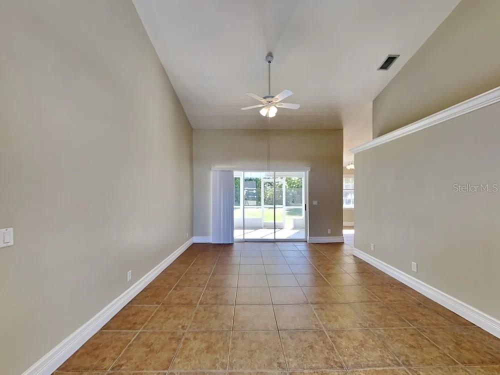 22 Cabello Street Punta Gorda, FL 33983 - Photo 2 of 15 an empty room with wooden floor and windows