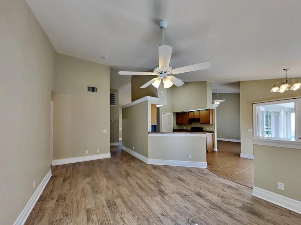 22 Cabello Street Punta Gorda, FL 33983 - Photo 5 of 15 a view of a livingroom with a fireplace a ceiling fan and wooden floor