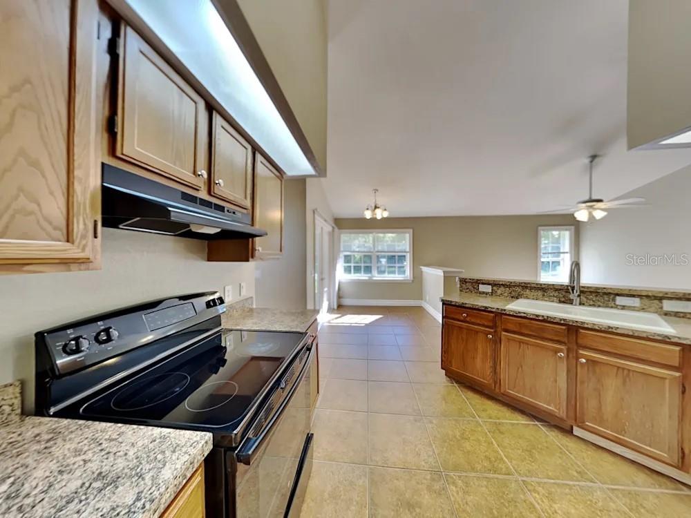 22 Cabello Street Punta Gorda, FL 33983 - Photo 6 of 15 a kitchen with a stove a sink and a microwave
