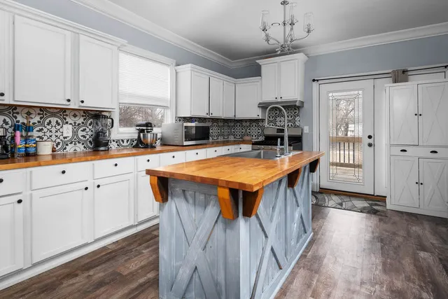 a kitchen with sink cabinets and wooden floor