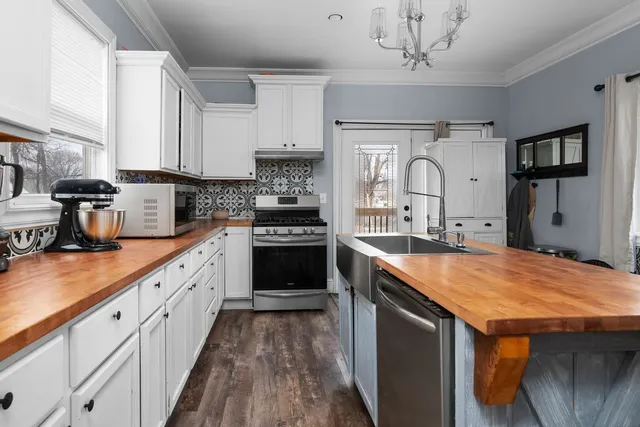 a kitchen with stainless steel appliances granite countertop a sink stove and refrigerator