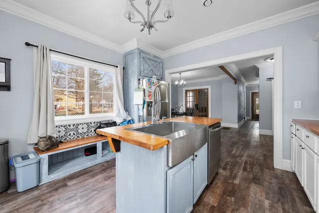 a kitchen with sink stove and refrigerator