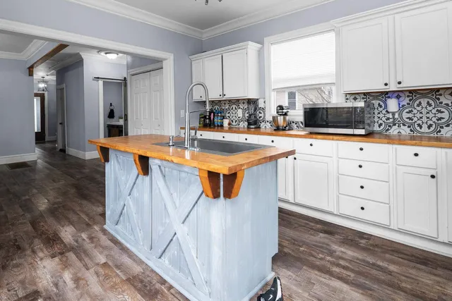 a kitchen with stainless steel appliances granite countertop a sink and cabinets