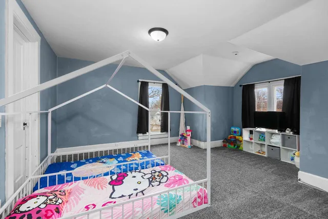 a bedroom with furniture and a flat screen tv