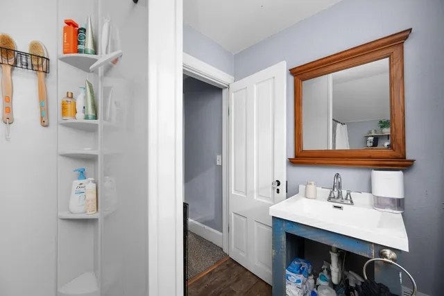 a bathroom with a sink vanity and a mirror