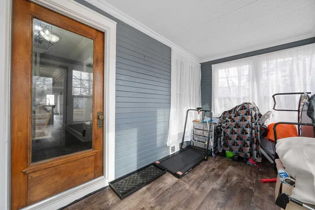 a front view of a house with a yard and trees